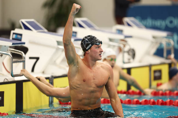 Grant House raising a fist in celebration in the pool