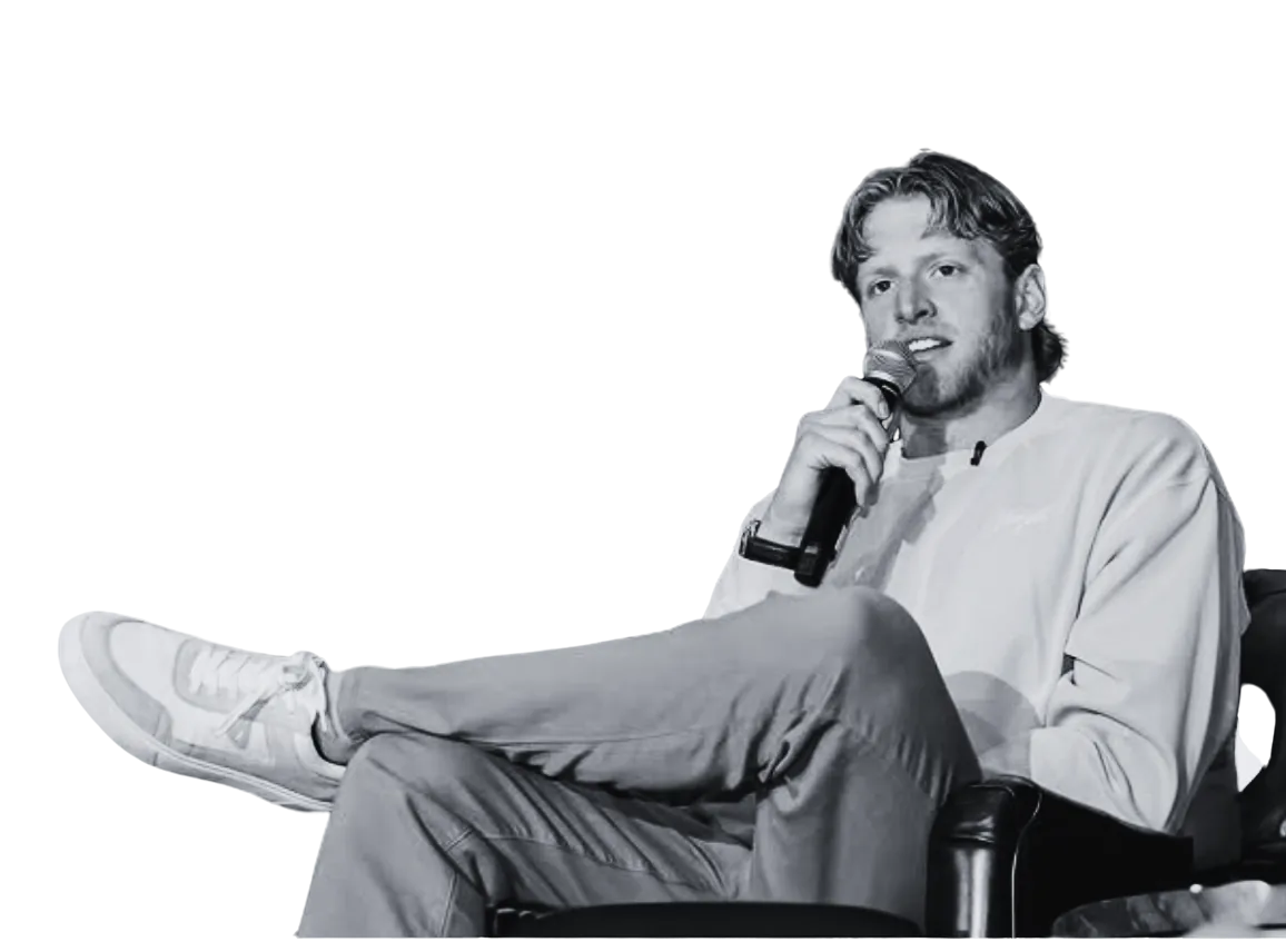 Grant House speaking into a microphone during a seated conversation